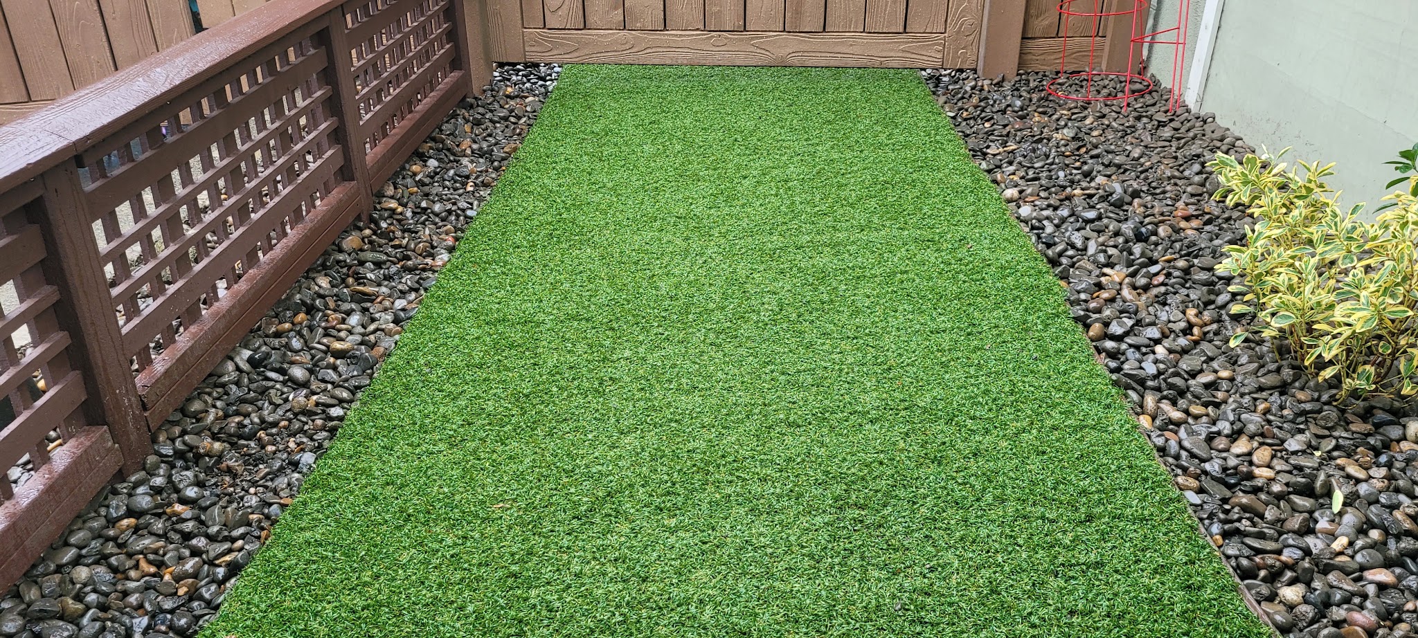Artificial turf installed with a river rock border